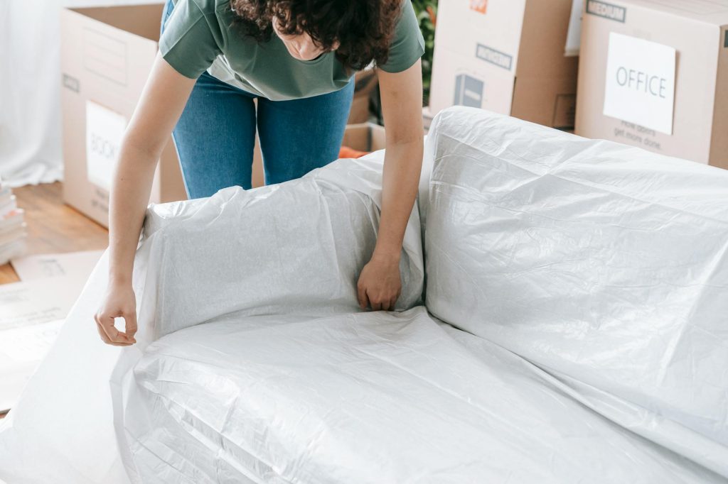 Team of professional house movers in Lavington packing furniture into a moving truck.