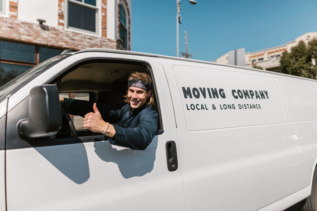 Professional movers carrying furniture out of a Nairobi apartment building.